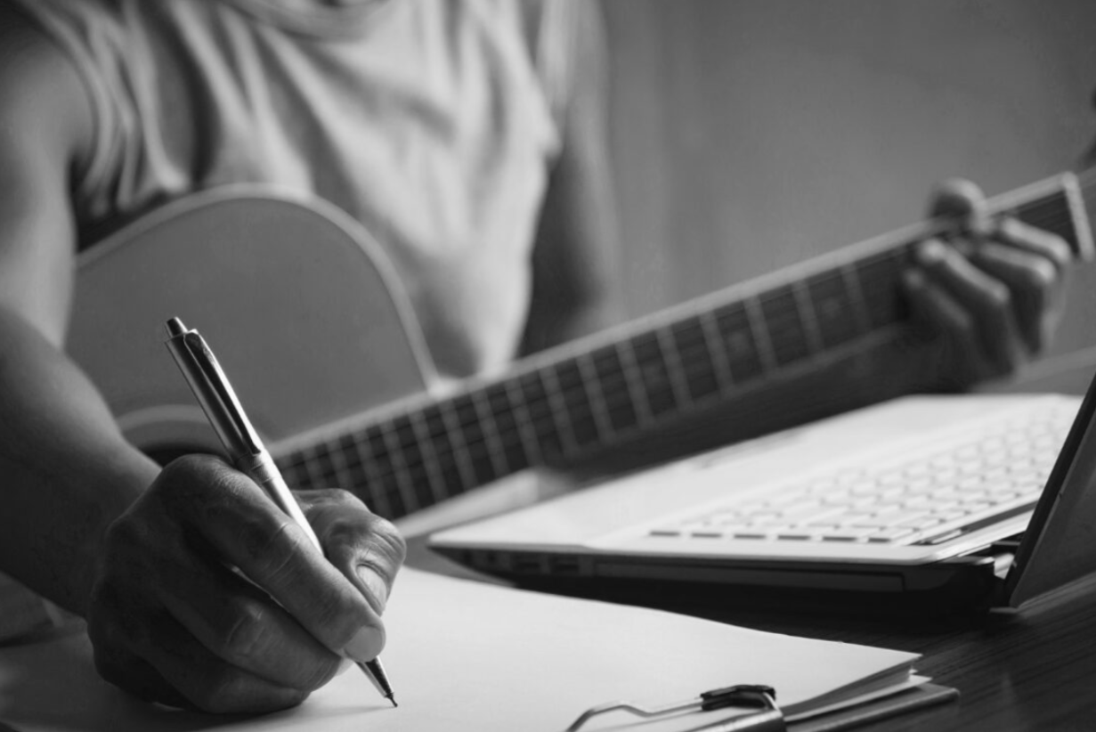 guitar in hand and writing